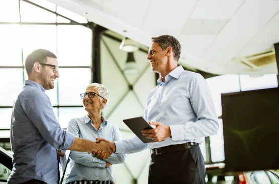 Business professionals shaking hands during a successful brokerage deal